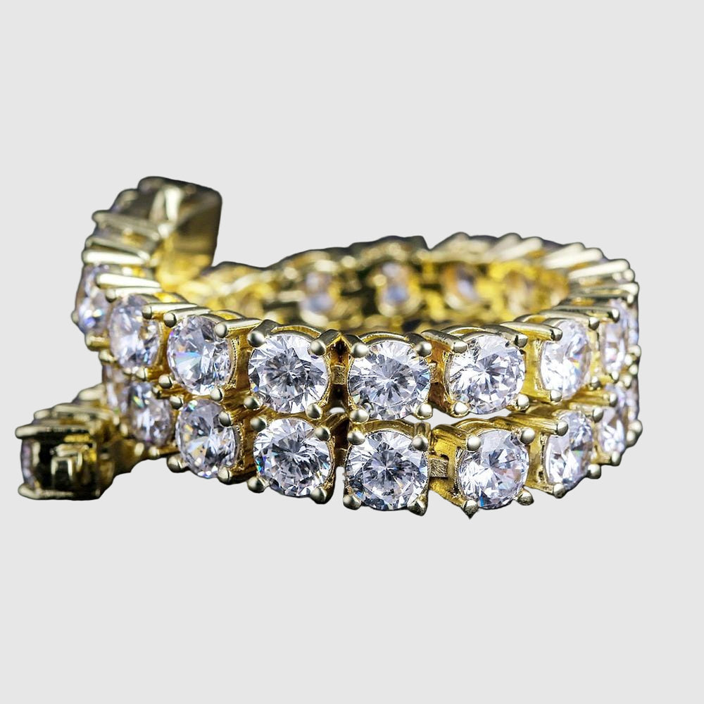 Gold bracelet with clear gemstones on a black background