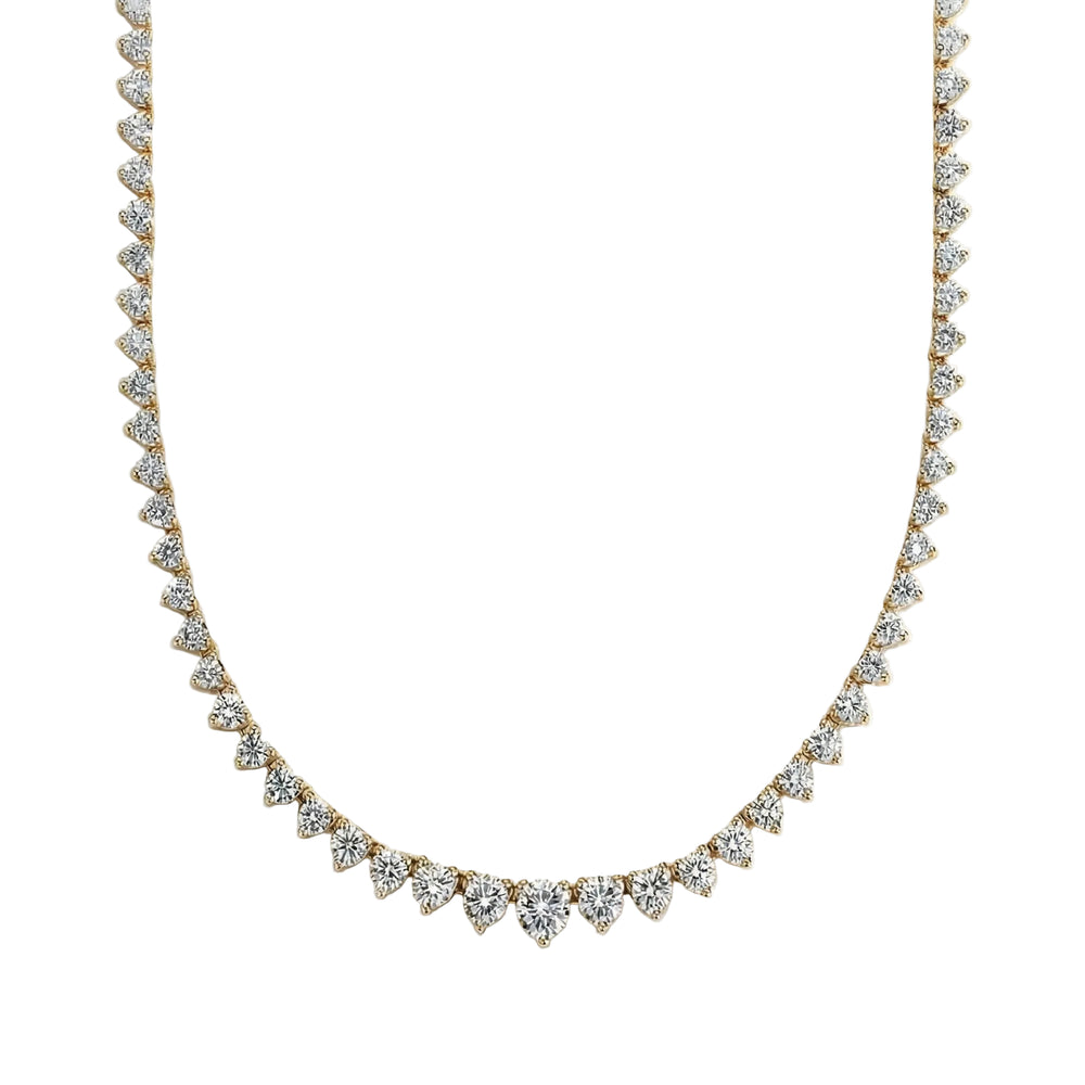 Gold necklace with clear stones on a light gray background