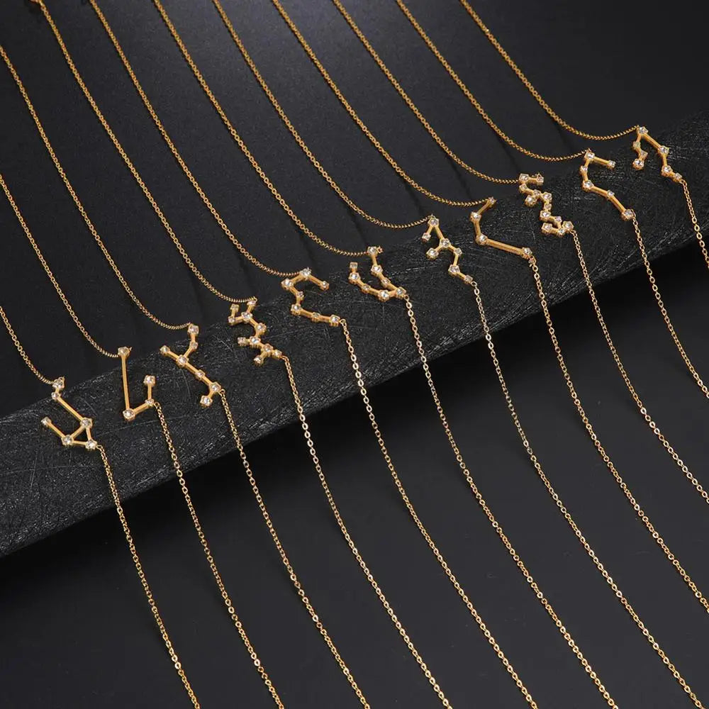 Gold necklaces with zodiac constellation pendants on a black background