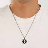 Necklace with a compass pendant worn by a person on a white background