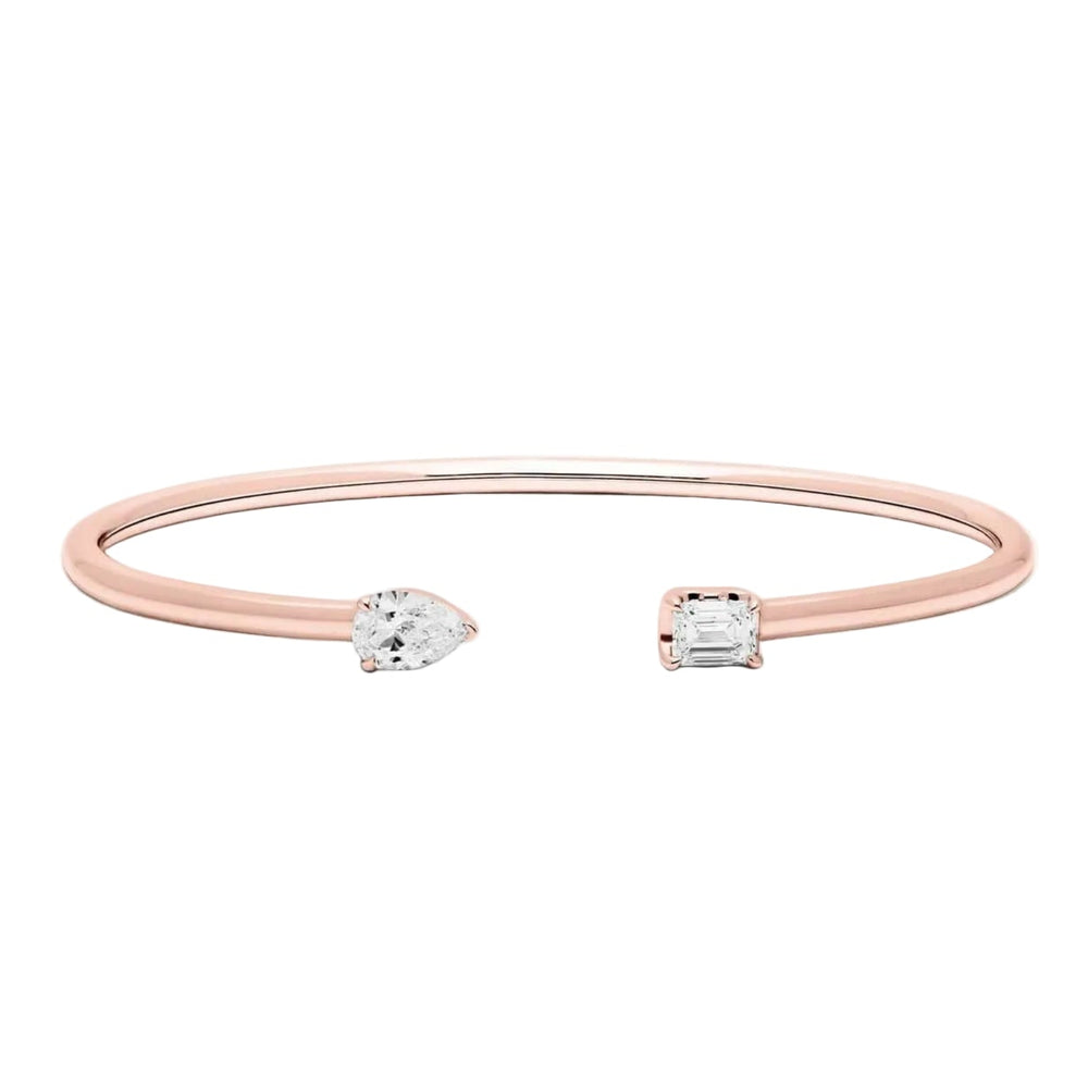 Rose gold bracelet with two clear diamonds on a white background