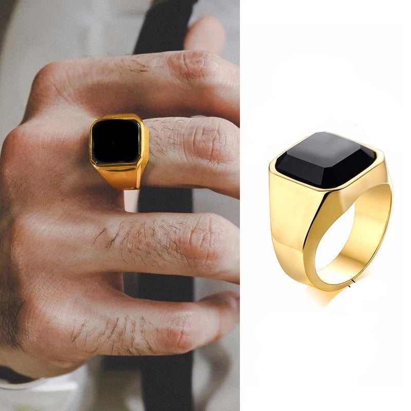 Gold ring with black stone on a hand, showing ring dimensions and material details.