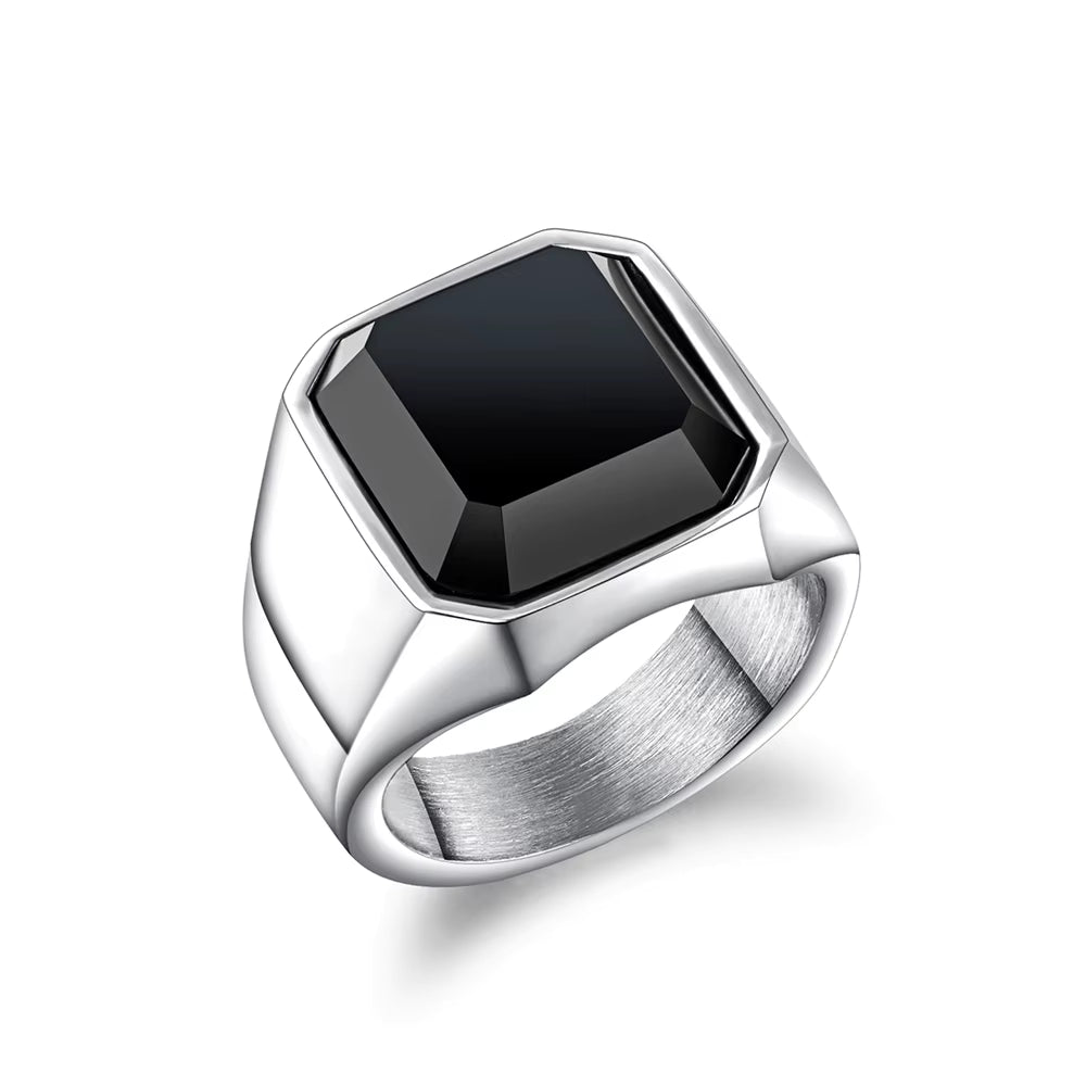 Silver ring with a black gemstone on a white background