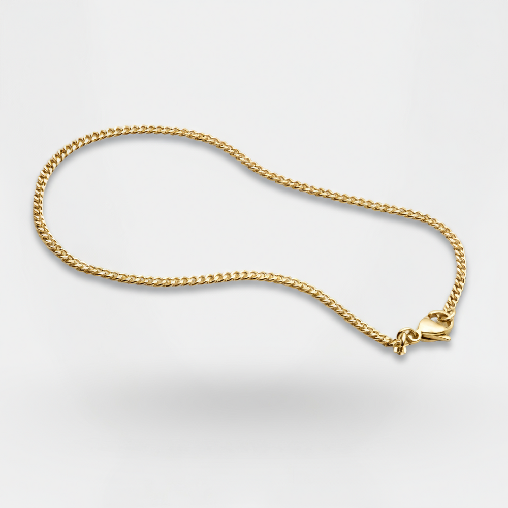 Gold chain necklace on a light gray background