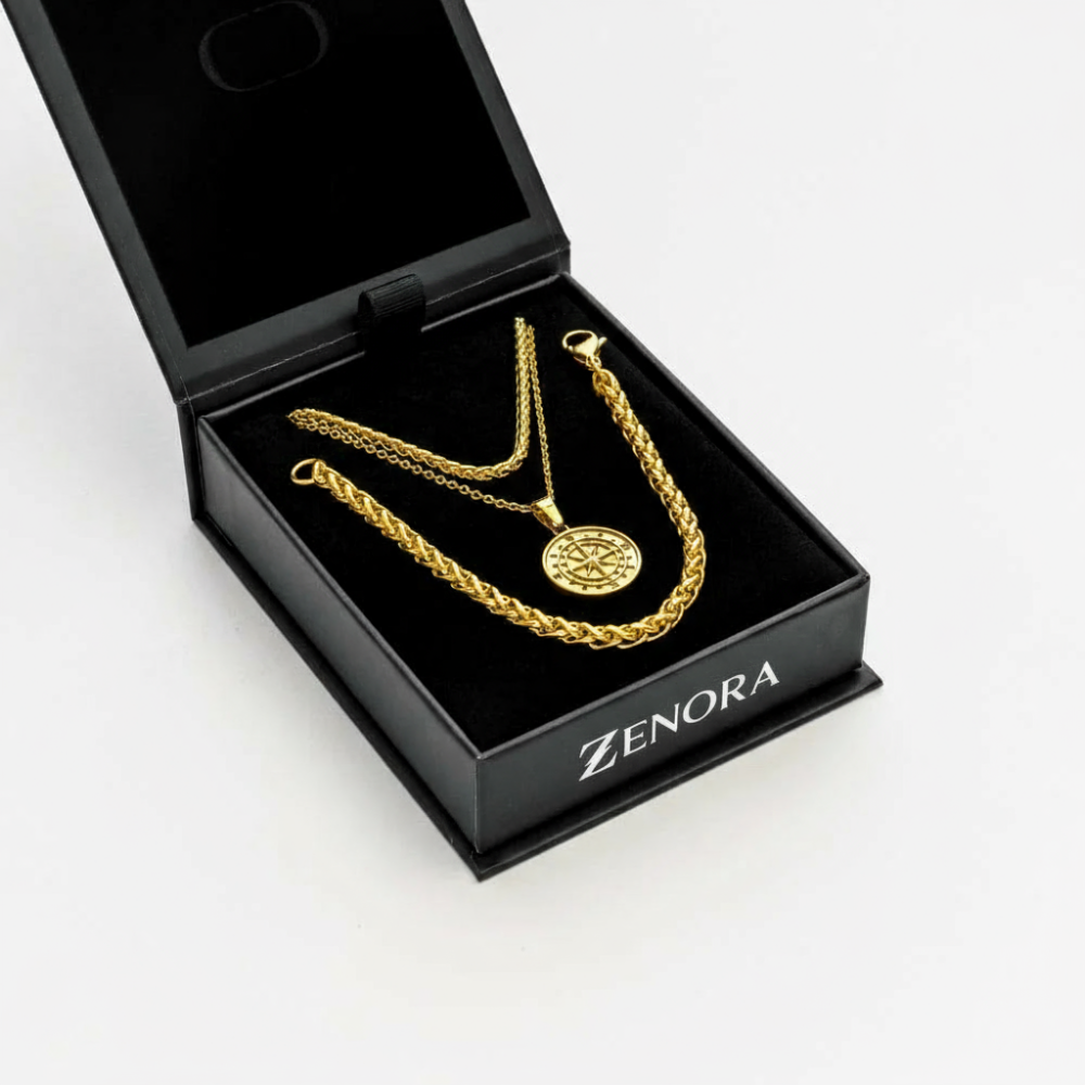 Gold necklace and chain in a black 'Zenora' jewelry box on a white background