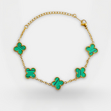 Necklace with green butterfly-shaped pendants on a gold chain against a white background