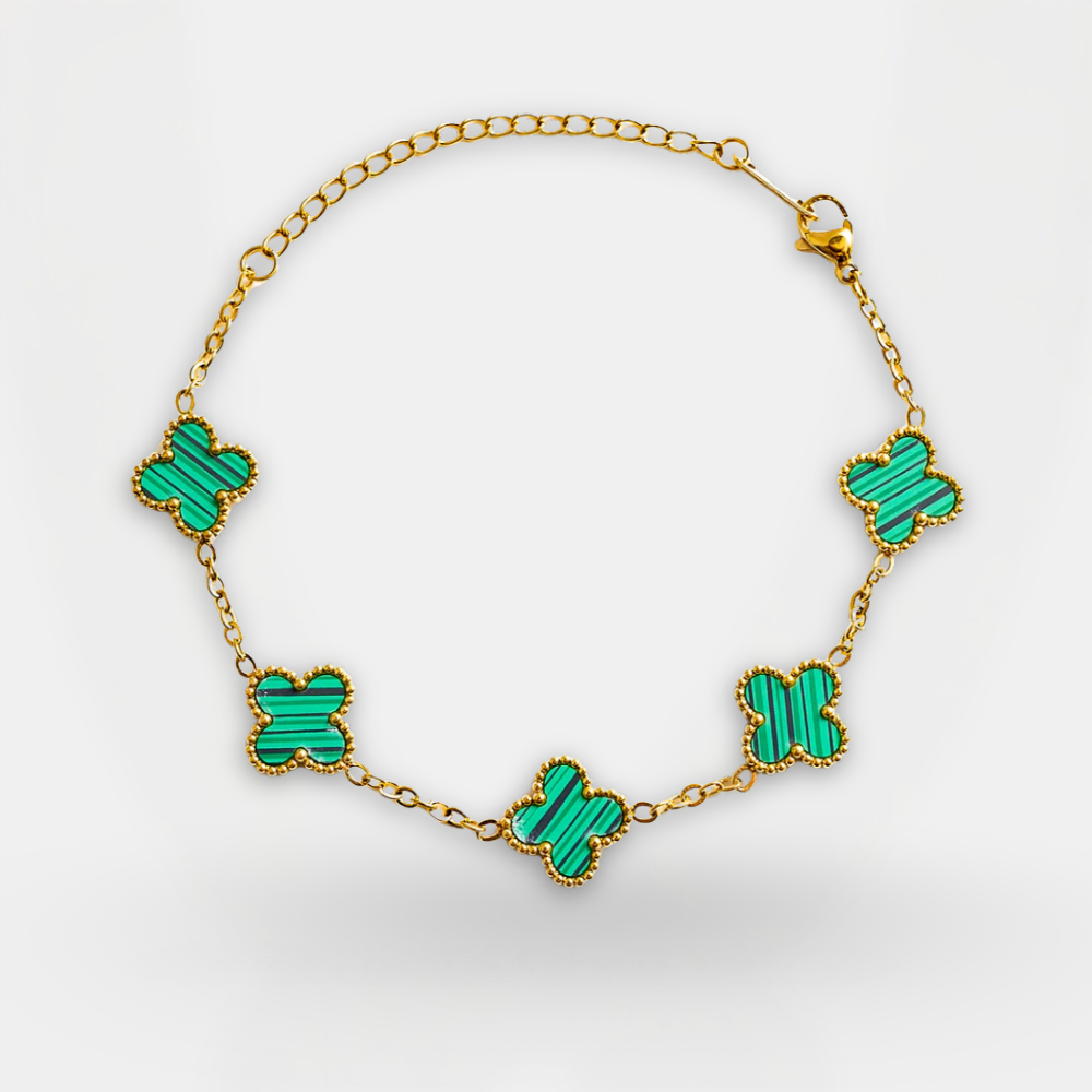 Necklace with green butterfly-shaped pendants on a gold chain against a white background
