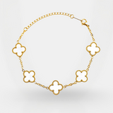 Gold necklace with clover-shaped links on a light gray background