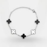 Bracelet with black clover-shaped charms on a white background