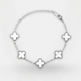 Silver bracelet with clover-shaped charms on a white background
