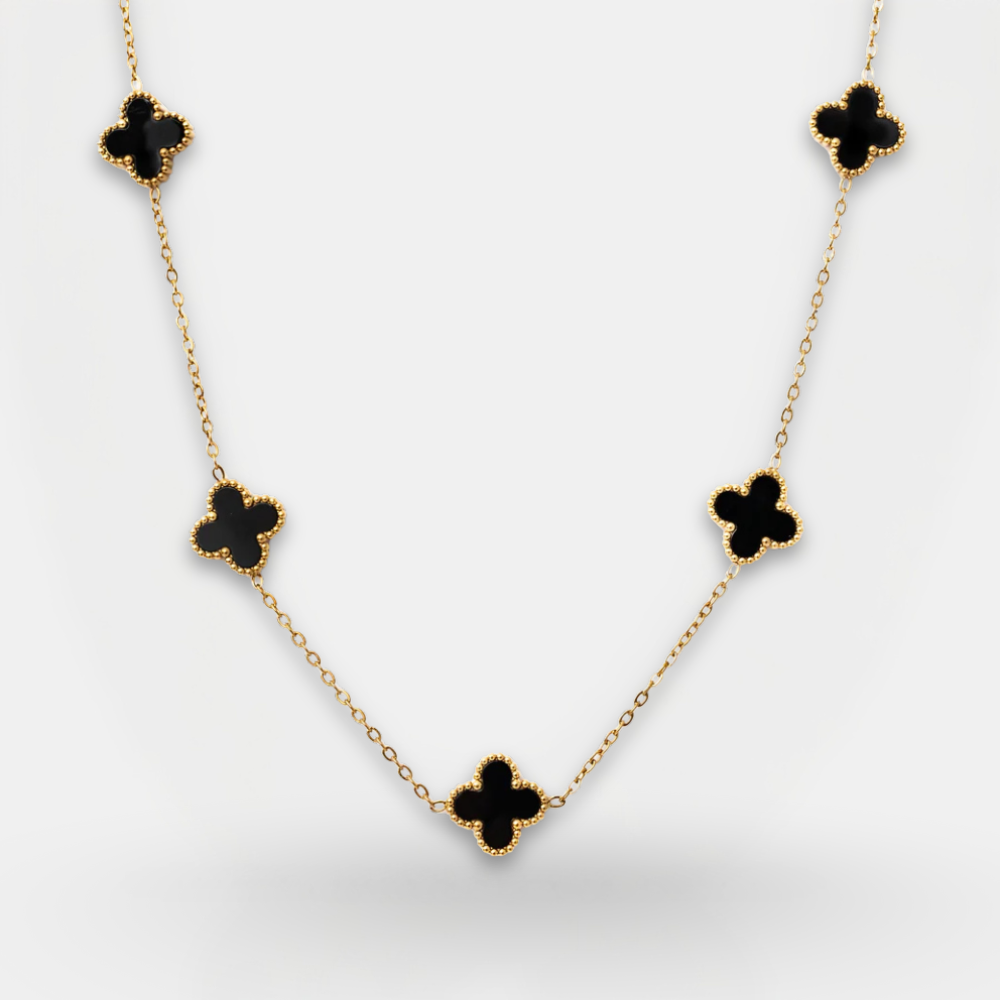 Necklace with black clover-shaped pendants on a light gray background