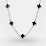 Necklace with black clover-shaped pendants on a white background