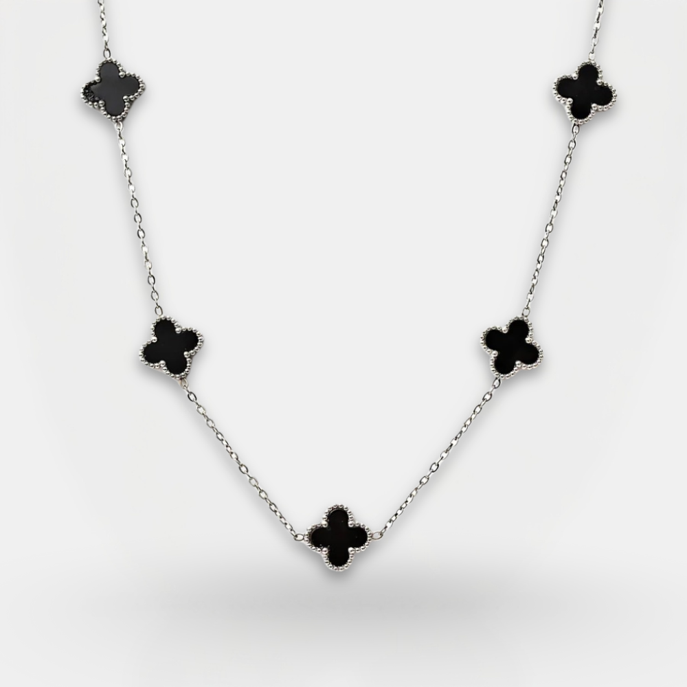Necklace with black clover-shaped pendants on a white background