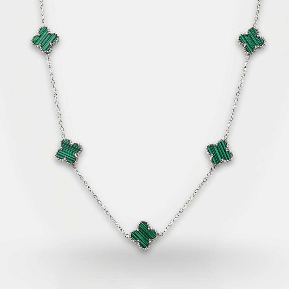 Necklace with green emerald-like stones on a white background
