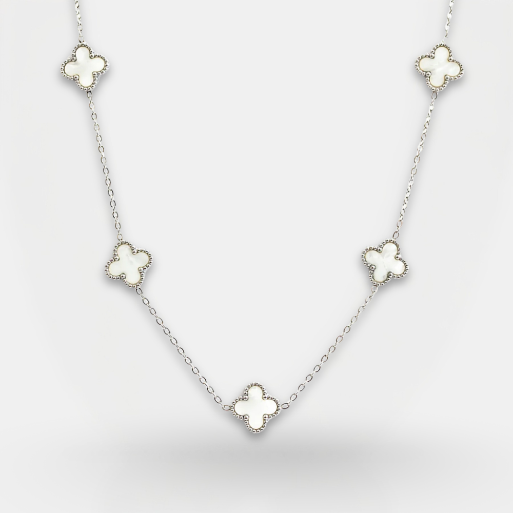 Necklace with four-leaf clover pendants on a light gray background