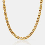 Gold chain necklace on a light gray background