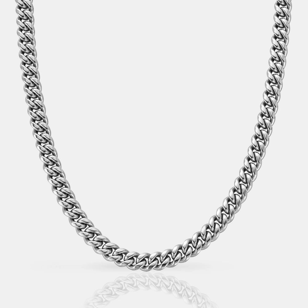 Silver chain necklace on a light gray background
