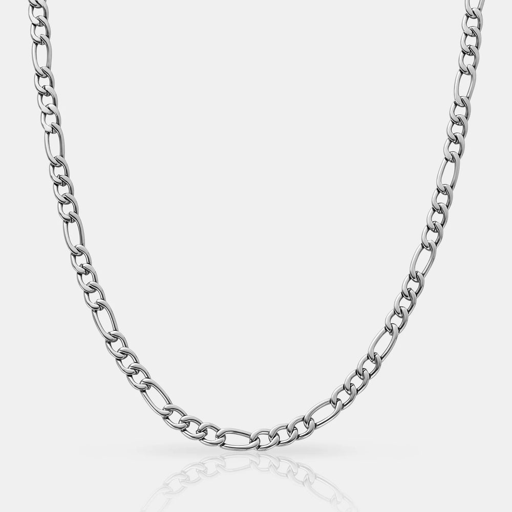Silver chain necklace on a light gray background