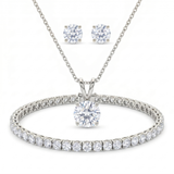 A silver-tone necklace and matching stud earrings set, each featuring a round brilliant-cut clear gemstone in a four-prong setting, displayed on a clean white background.