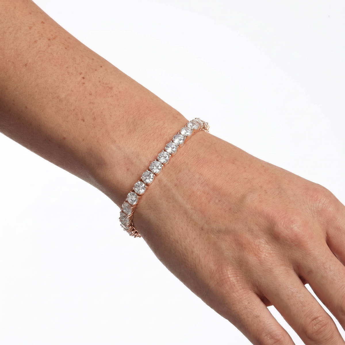Rose gold 5mm moissanite tennis bracelet styled on hand