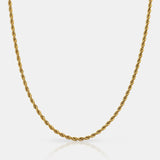 Gold rope chain necklace on a light gray background