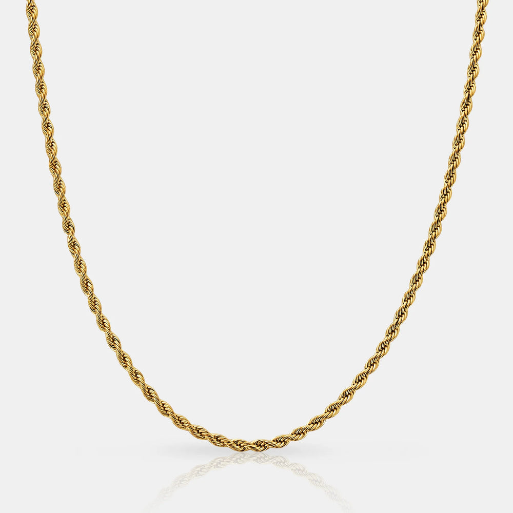 Gold rope chain necklace on a light gray background