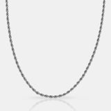 Silver rope chain necklace on a light gray background