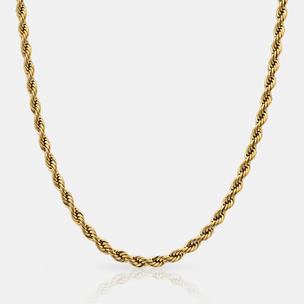 Gold rope chain necklace on a light gray background