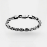 Silver braided bracelet on a light gray background