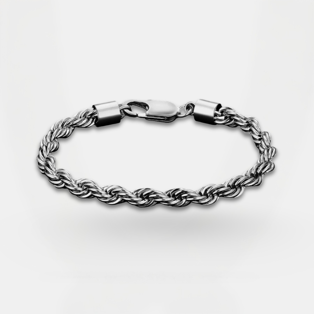 Silver braided bracelet on a light gray background