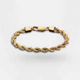 Gold braided bracelet on a light gray background