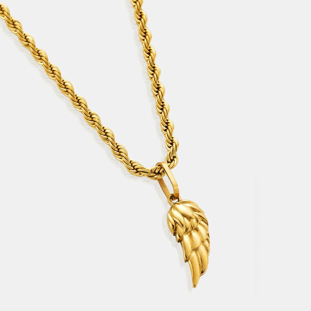 Gold wing-shaped pendant on a gold chain against a white background