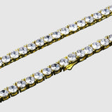 Gold chain with clear crystals on a black background