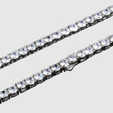 Two diamond tennis bracelets on a black background