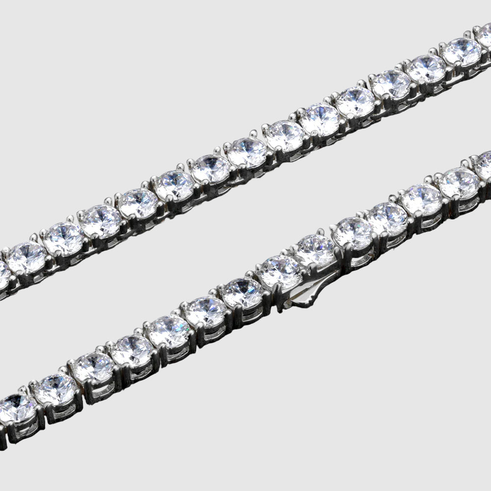 Two diamond tennis bracelets on a black background