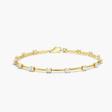 Gold bracelet with small diamonds on a white background