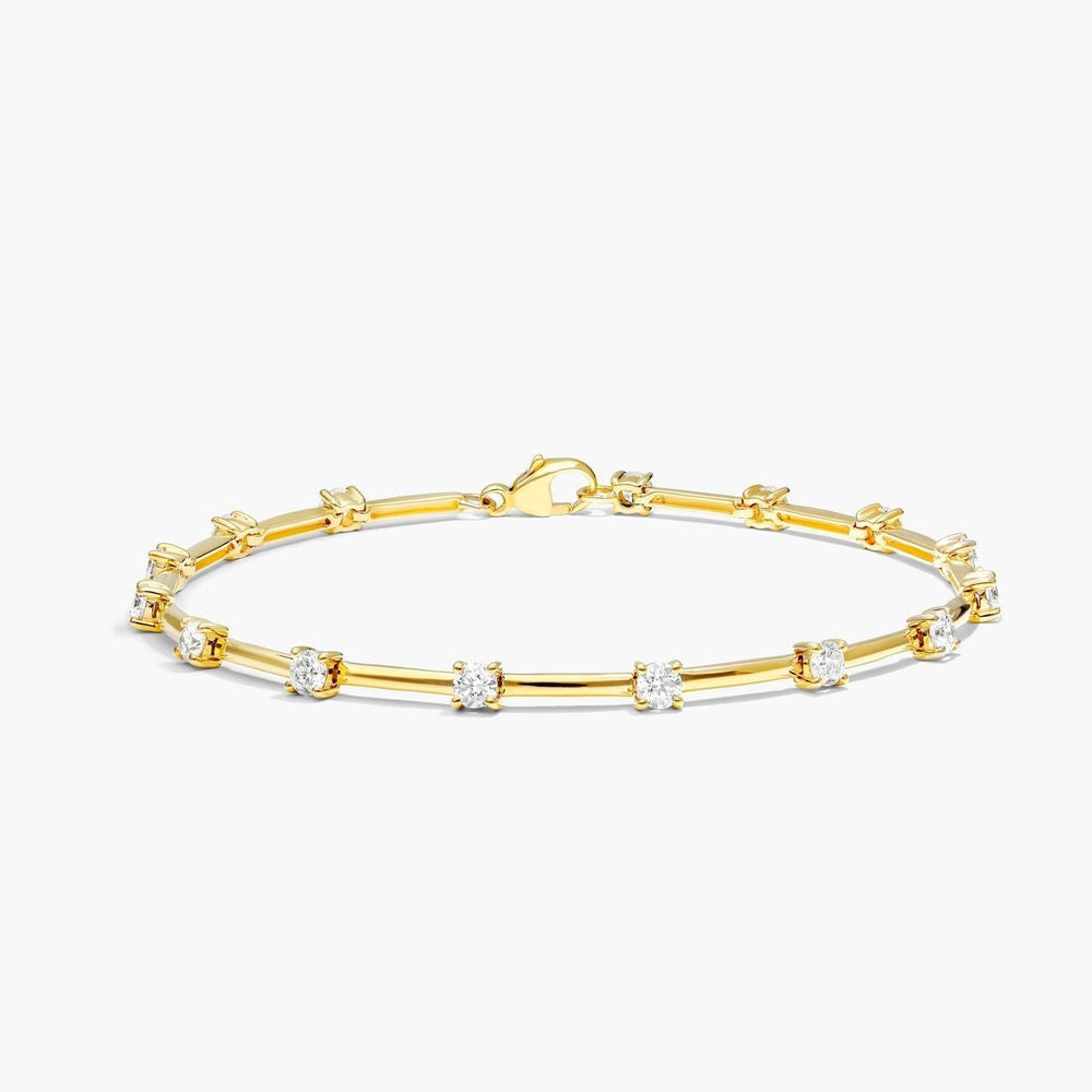 Gold bracelet with small diamonds on a white background