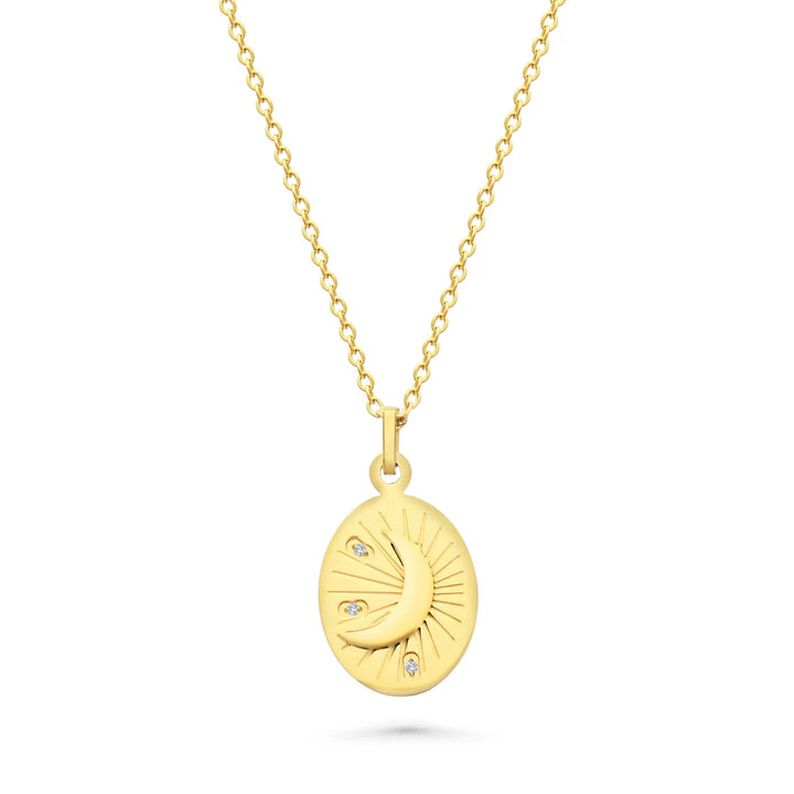 Gold necklace with a pendant featuring a moon design on a white background