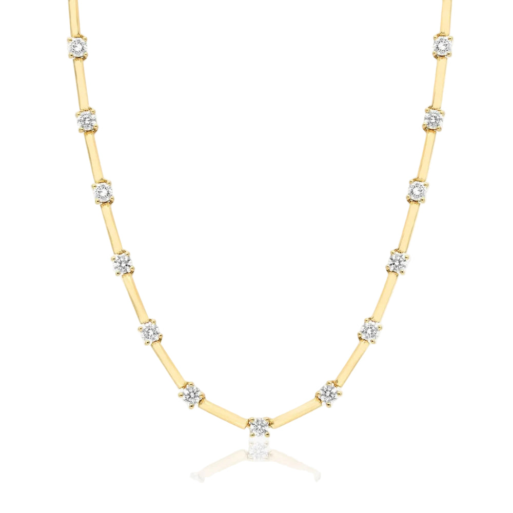 Gold necklace with diamond beads on a white background