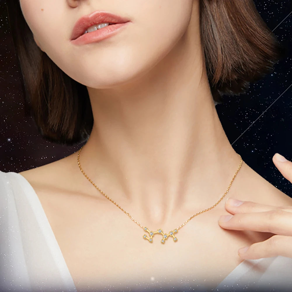 Woman wearing a gold necklace against a dark, starry background