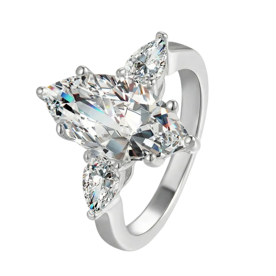 Diamond ring with three clear gemstones on a white background