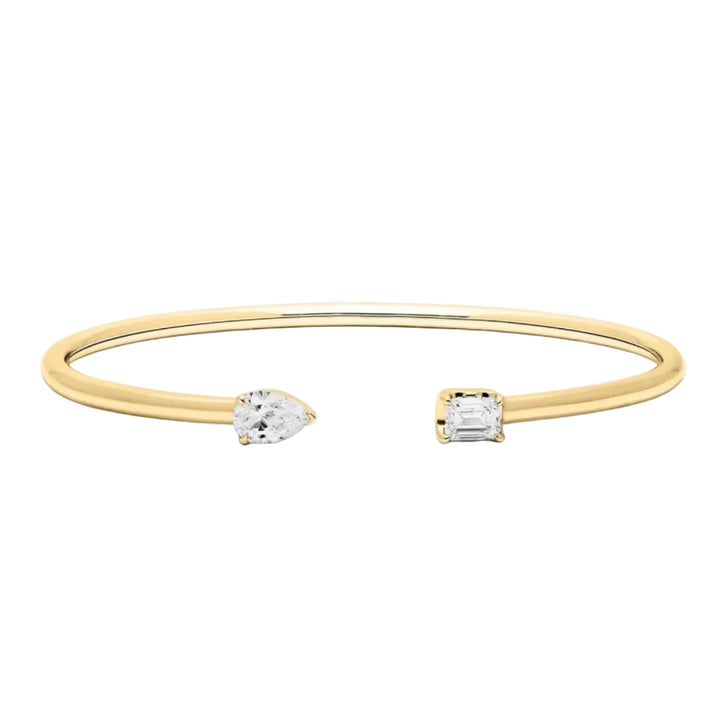 Gold bracelet with two diamond pendants on a white background