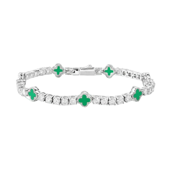 Silver bracelet with green gemstones on a white background