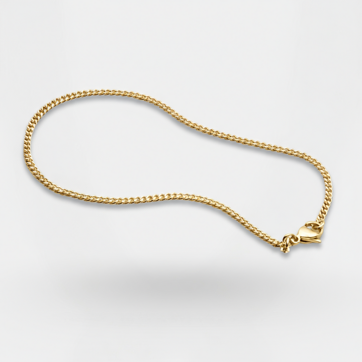Gold chain necklace on a light gray background