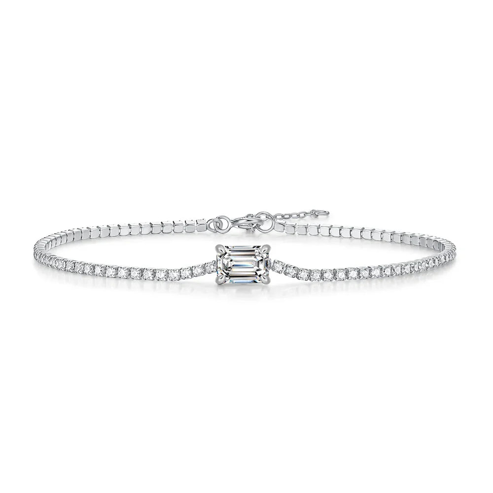 Diamond bracelet with a central emerald-cut diamond on a white background