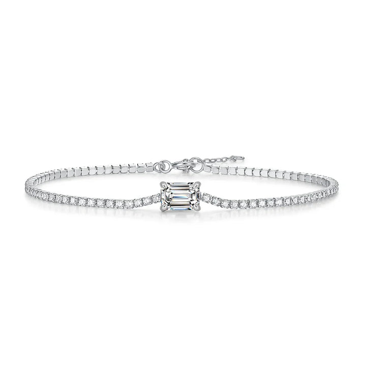 Diamond bracelet with a central emerald-cut diamond on a white background