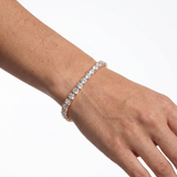 Rose gold 5mm moissanite tennis bracelet styled on hand