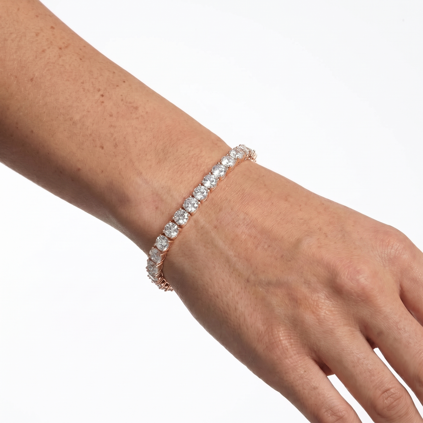 Rose gold 5mm moissanite tennis bracelet styled on hand